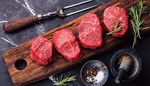 Raw Steaks on Cutting Board